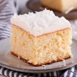 coconut cake with coconut butter cream on a plate
