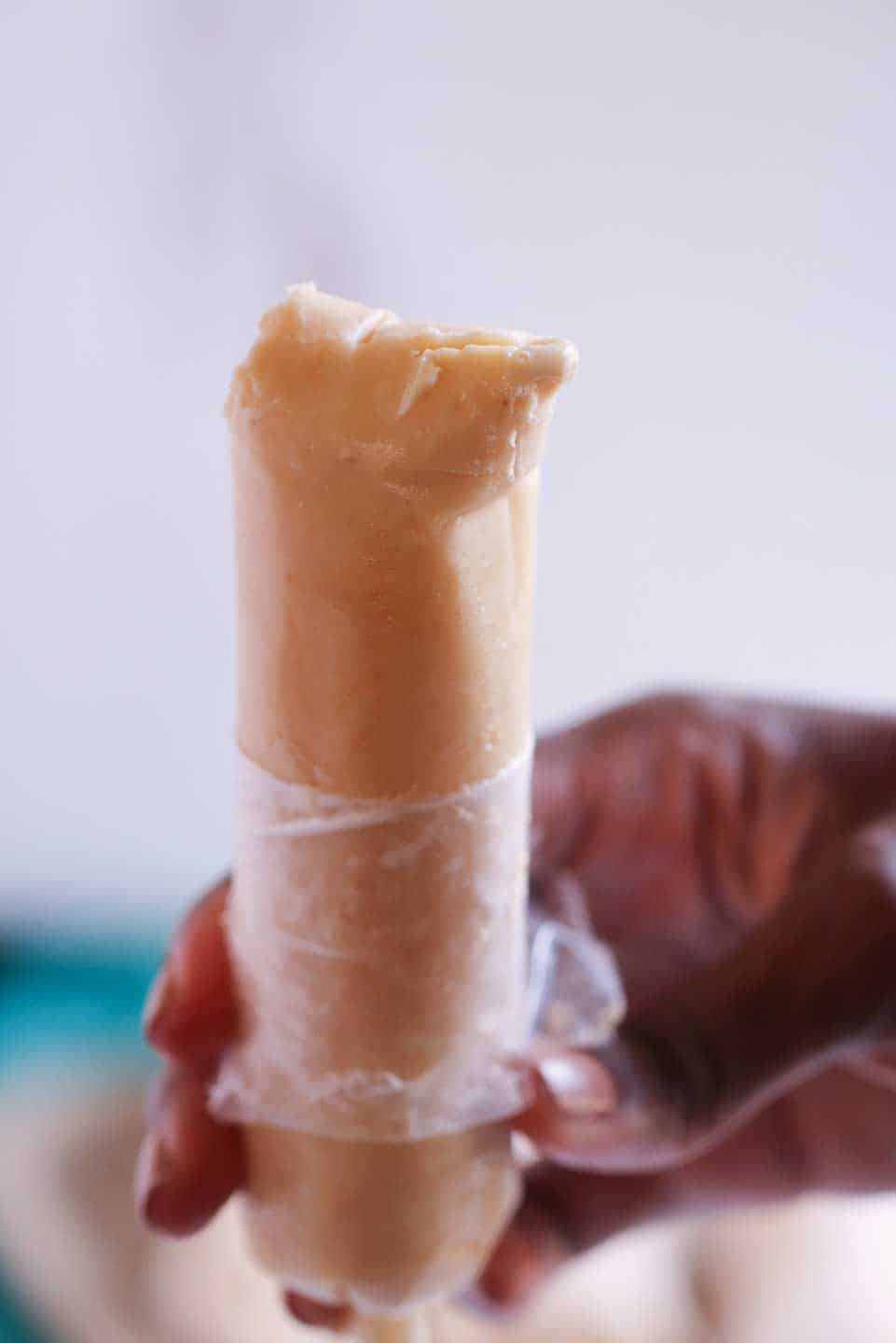 upclose shot of frozen custard dessert with plastic peeled back