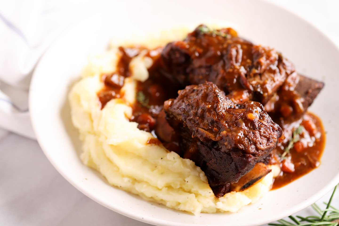tender short ribs plated with mashed potatoes