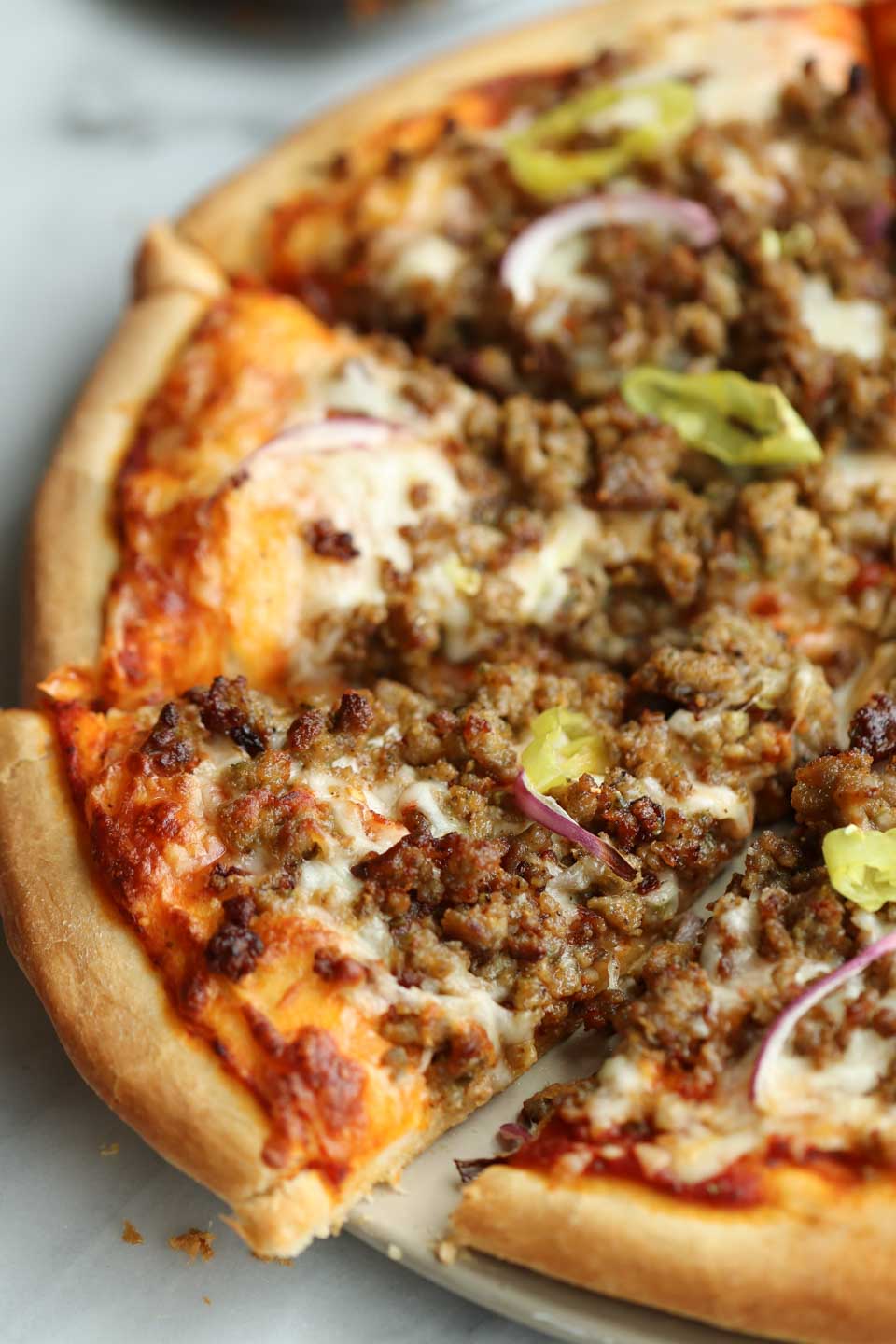 sausage pizza with red onions and pepperoncini 