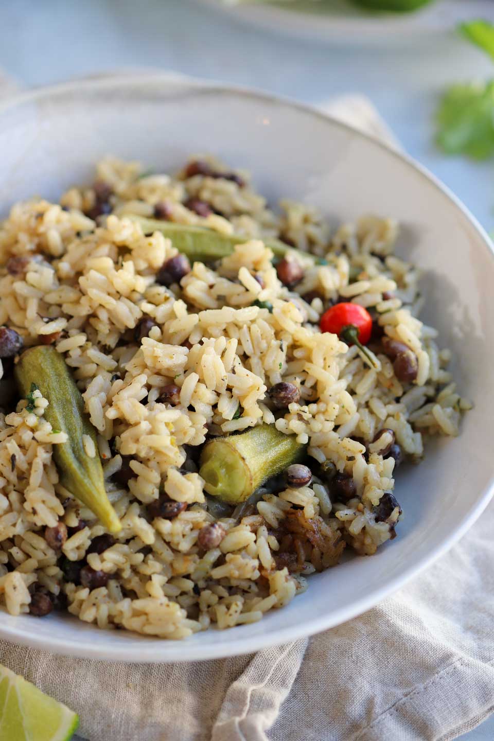 pigeon peas rice in a bowl with okra and a pepper