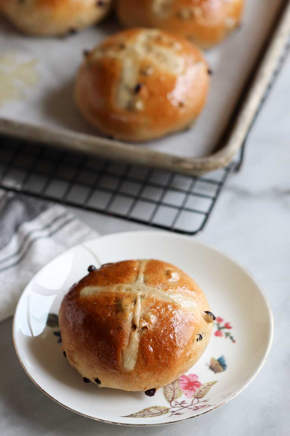 Classic hot cross buns with traditional spices like clove, cinnamon and orange zest made eggless
