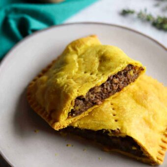 over head shot of Jamaican meat pie cut on a plate