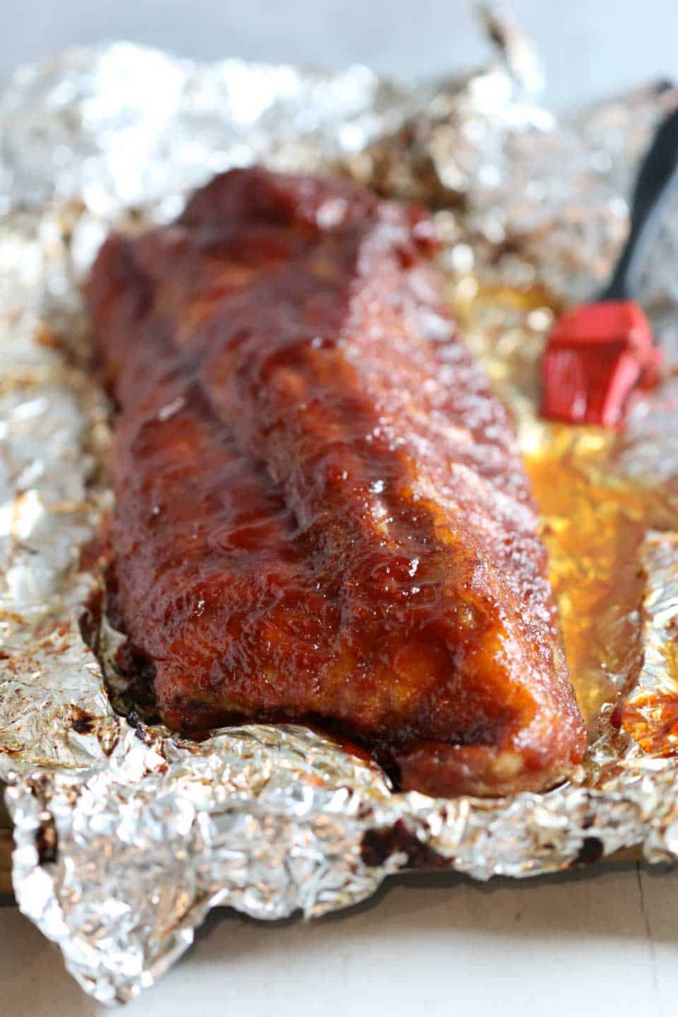 Succulent BBQ Ribs made in the oven with a homemade BBQ sauce.