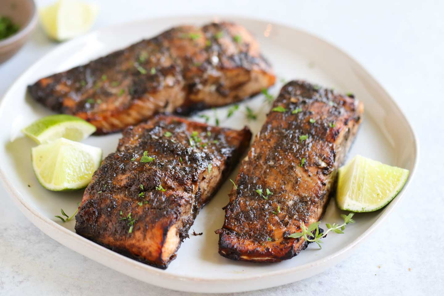 Delicious jerk salmon garnished with cilantro and lime