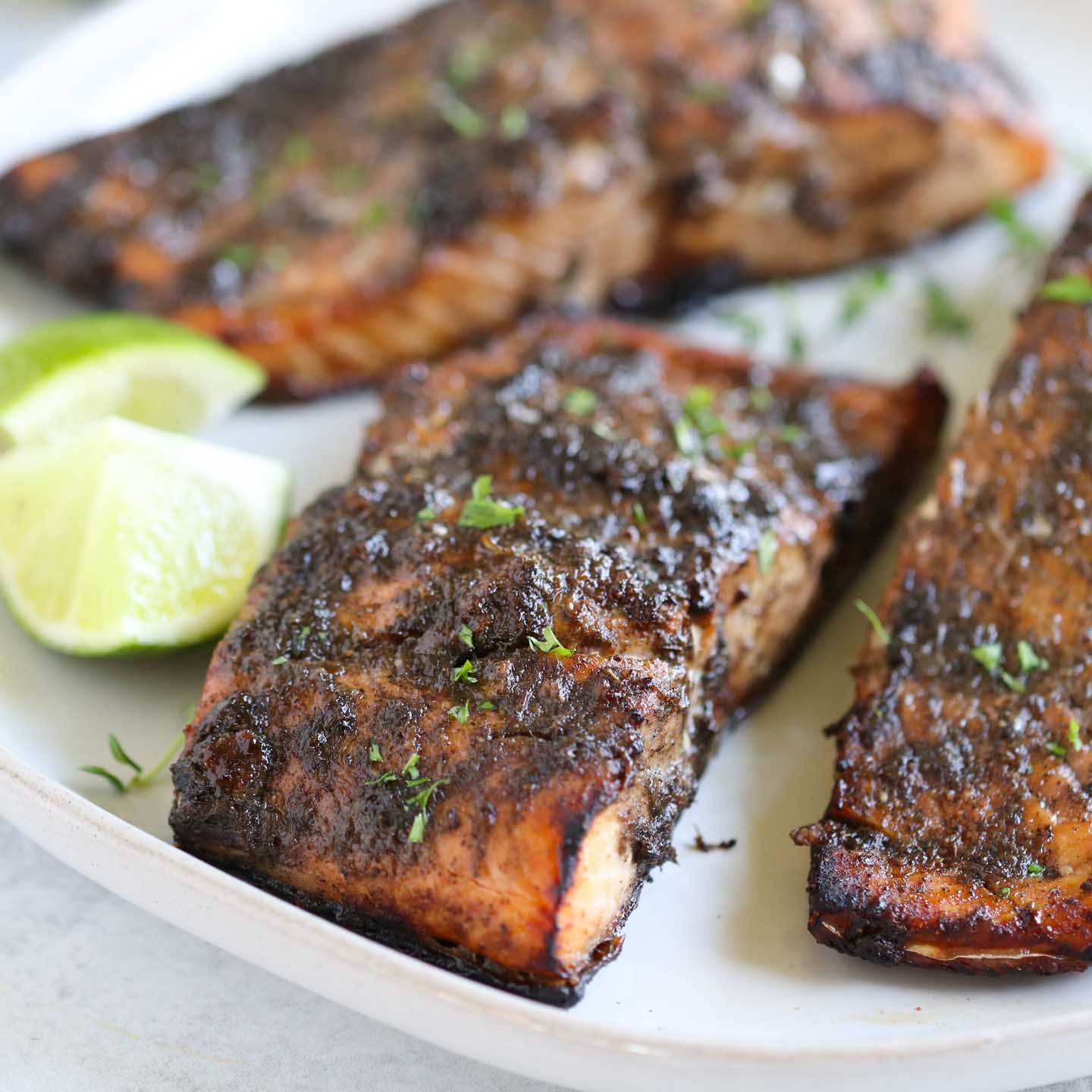 A plate of jerk salmon with a golden-brown crust